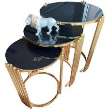 Black glass nesting side tables with gold metal frame in a modern living room, Nairobi Kenya