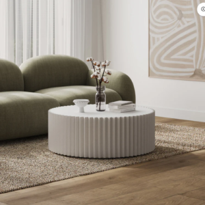 White round coffee table with ribbed cylindrical base and smooth glossy top