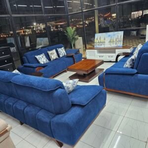 Royal blue fabric sofa set with 3 seater, 2 seater, and 1 seater plus patterned cushions in a Nairobi showroom