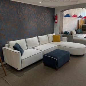 White L shape sectional sofa with curved chaise and black piping, plus matching dark ottoman, modern living room seating
