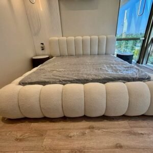 Cream ivory boucle cloud bed frame with padded footboard and vertical channel headboard, shown with mattress, available in 5x6 and 6x6 in Kenya.