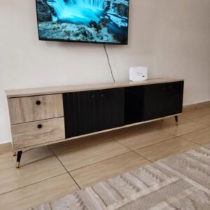 modern black and wood TV cabinet with drawers and storage used as entertainment unit in living room Kenya