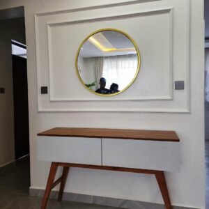modern console table with wood top and white drawers placed under round wall mirror in stylish entryway Kenya