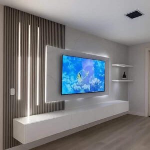 Minimalist TV wall with slat panel, LED light strips and floating console in a modern Kenya living room