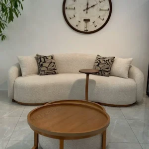 round coffee table with wooden top and upholstered base in Nairobi living room