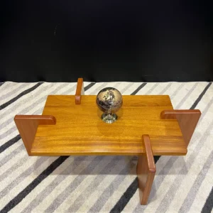 sculptural wooden coffee table with geometric legs in Nairobi living room