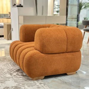 Orange textured accent chair with rounded arms and ribbed seat for modern interiors in Kenya