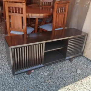 Modern black TV stand with dark top, slatted side panels, and open shelf for Kenya living rooms
