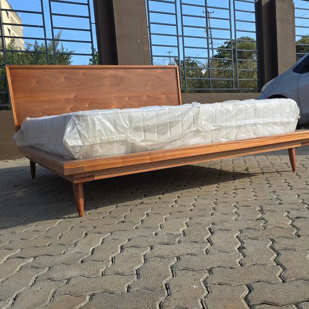Wooden platform bed frame with wide headboard and low profile base