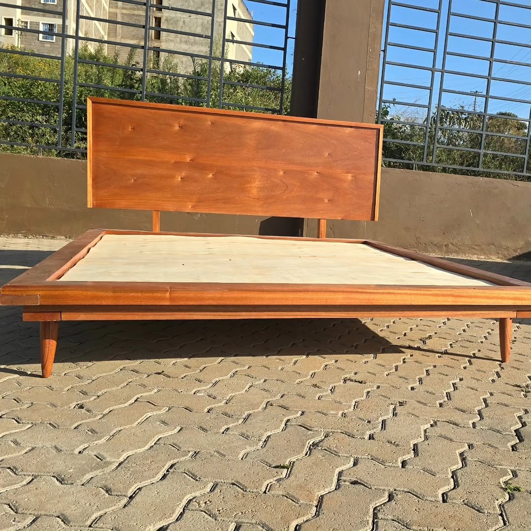 Wooden platform bed frame with wide headboard and low profile base
