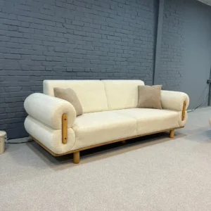 Modern cream lounge chair with wood-tone arms and rounded back for Kenya interiors