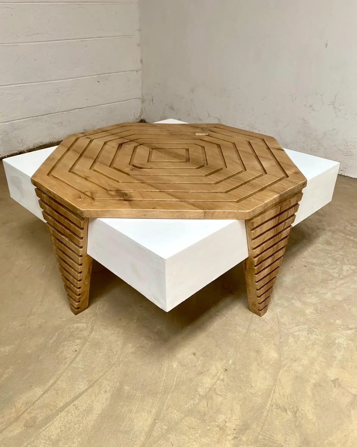 Geometric wooden coffee table with carved octagonal top and white block sections for Kenya living rooms