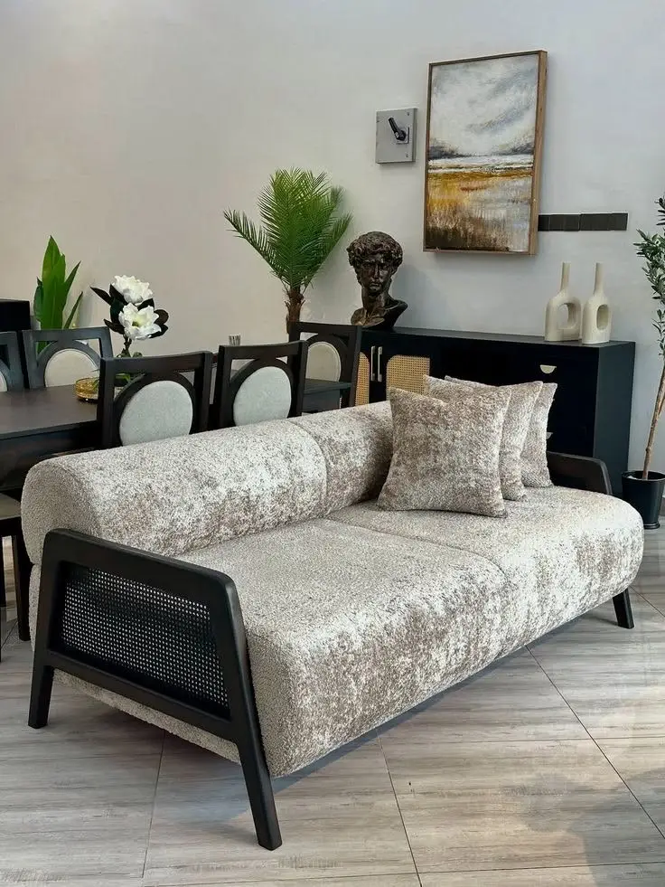 Modern 3 seater sofa with light textured upholstery and black cane-style side panels in Kenya