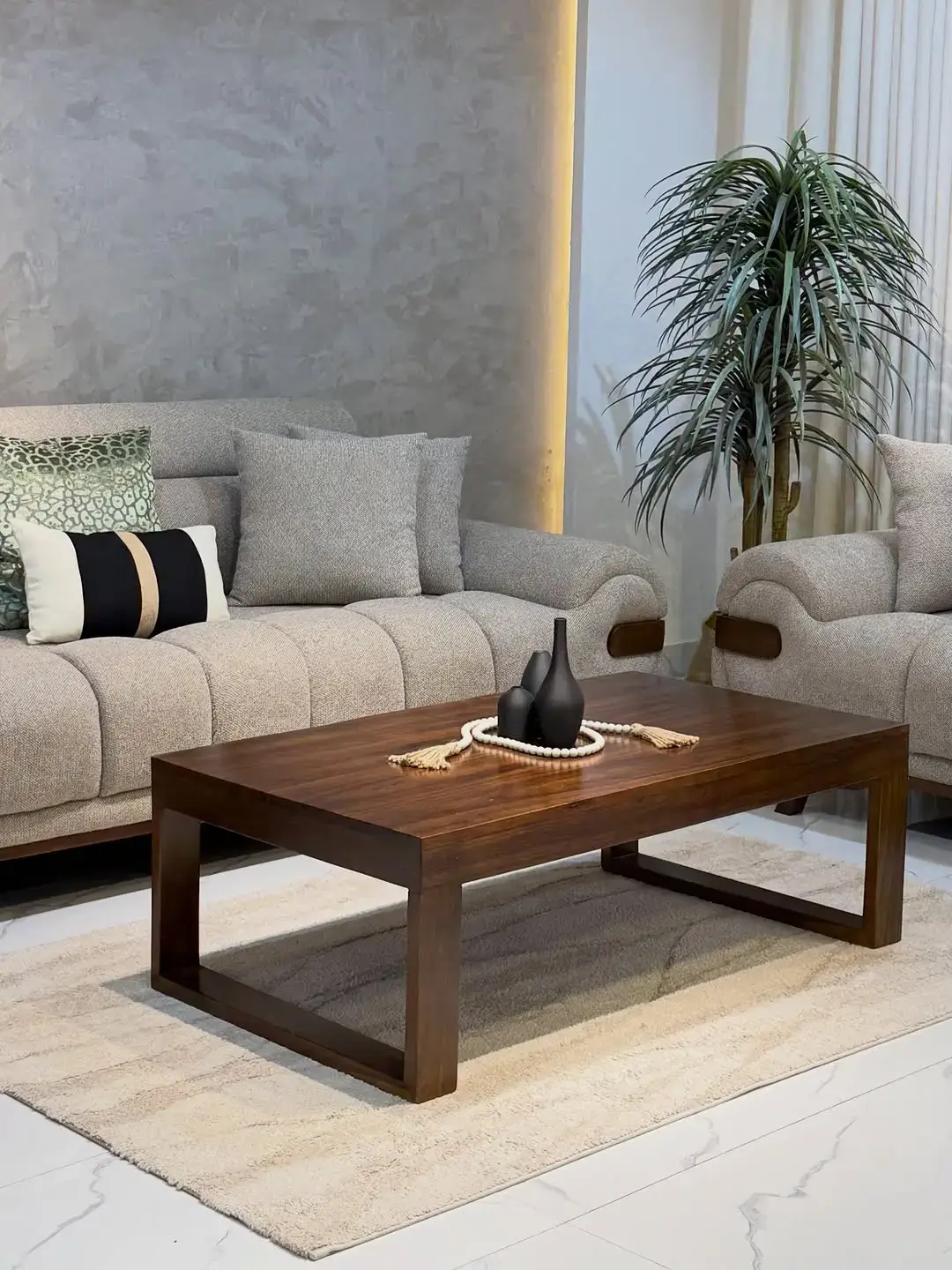 Modern beige sofa set with rolled arm and dark accent detail for a Kenya living room