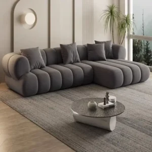 Grey channel tufted sectional sofa with chaise and rounded arms for modern living rooms in Kenya