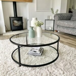 Round glass coffee table with black circular frame and lower shelf for modern living rooms in Kenya