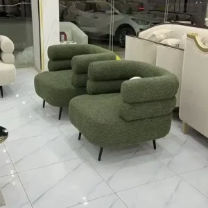 Green textured accent chair with rounded seat and wraparound back for Kenya interiors