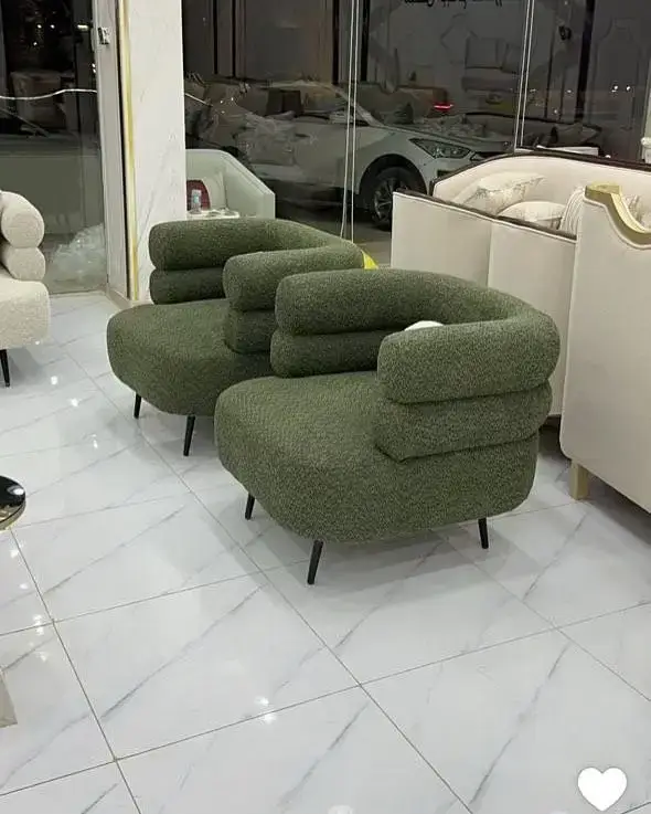 Green textured accent chair with rounded seat and wraparound back for Kenya interiors