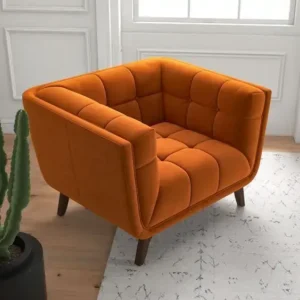 Orange tufted accent chair with padded arms and angled legs for modern Kenya lounges