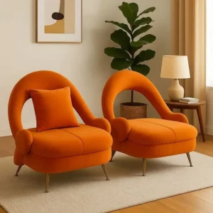 Orange accent chair with curved back and dark tapered legs for Kenya lounge spaces