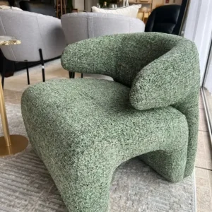 Green textured accent chair with rounded seat and wraparound back for Kenya interiors