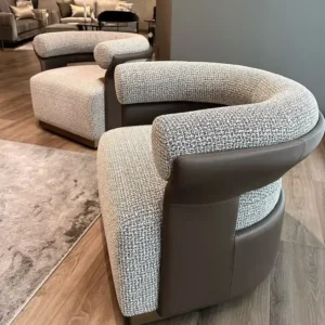 Cream woven accent chair with dark outer shell and curved back for Nairobi lounges