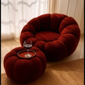 Deep red petal-style lounge chair with matching round ottoman for Kenya interiors
