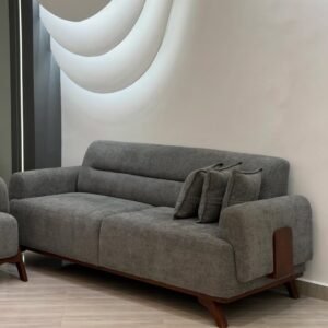 Grey sofa set Kenya with three-seater sofa, padded arms, wood-tone accents and throw pillows