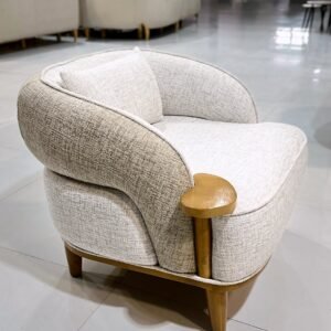 Cream barrel accent chair with curved back, textured upholstery and side-table detail for Kenya interiors