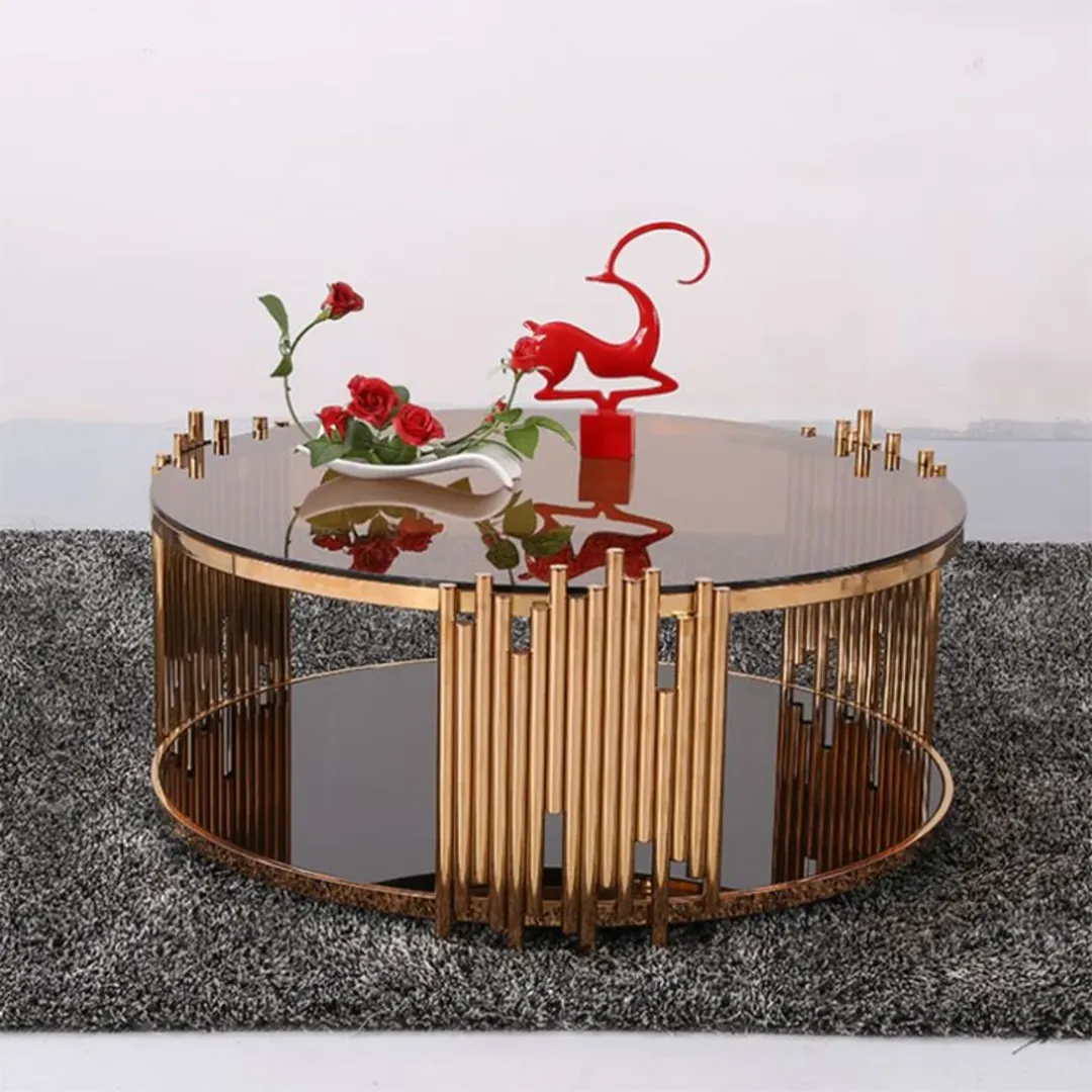 Round glass coffee table with smoked top and gold-tone rod frame for modern Kenya living rooms