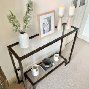 Black glass-style console table with lower shelf for entryways and Nairobi interiors