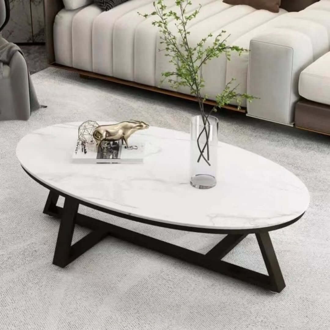Oval marble-look coffee table with white top and black geometric frame for modern living rooms in Kenya