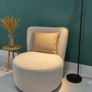 Cream accent chair with rounded seat, curved high back and wood-tone legs for Kenya interiors