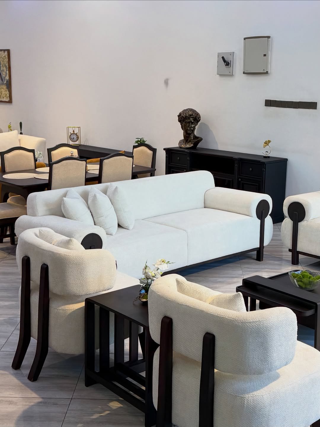 Ivory 3 seater sofa Kenya with rounded roll arms, black side accents and throw pillows