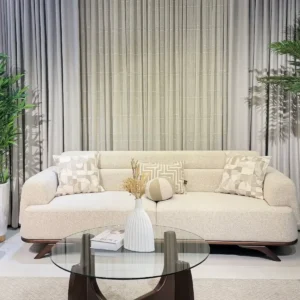 Cream sofa set Kenya with rounded arms, wooden accents and matching throw pillows