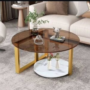 Round glass coffee table with amber smoked top, gold-tone frame and lower shelf for Kenya lounges