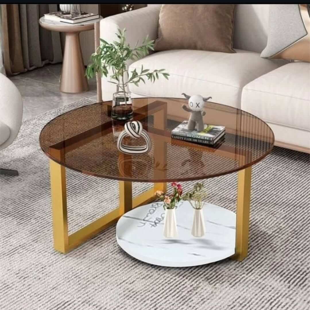 Round glass coffee table with amber smoked top, gold-tone frame and lower shelf for Kenya lounges
