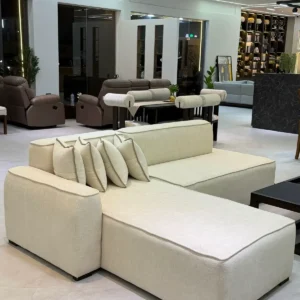 L shape sofa Kenya with cream upholstery, chaise lounge and matching throw pillows