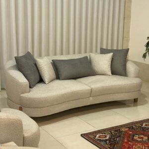 Cream 3 seater sofa with rounded arms, soft upholstery and wood-tone legs for Kenya living rooms