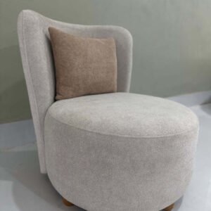 Cream accent chair with rounded seat, curved backrest and wood-tone legs for Kenya interiors