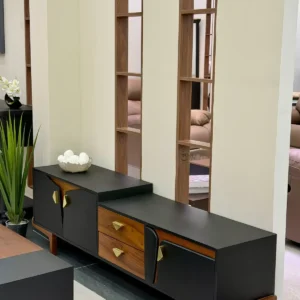 Black TV stand Kenya with wood-look drawers, gold handles and raised wooden legs