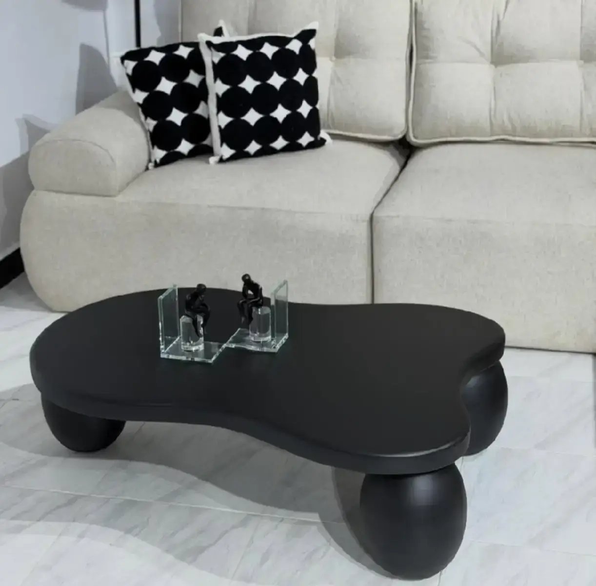 Black coffee table Kenya with organic rounded top and ball-style legs for modern living rooms