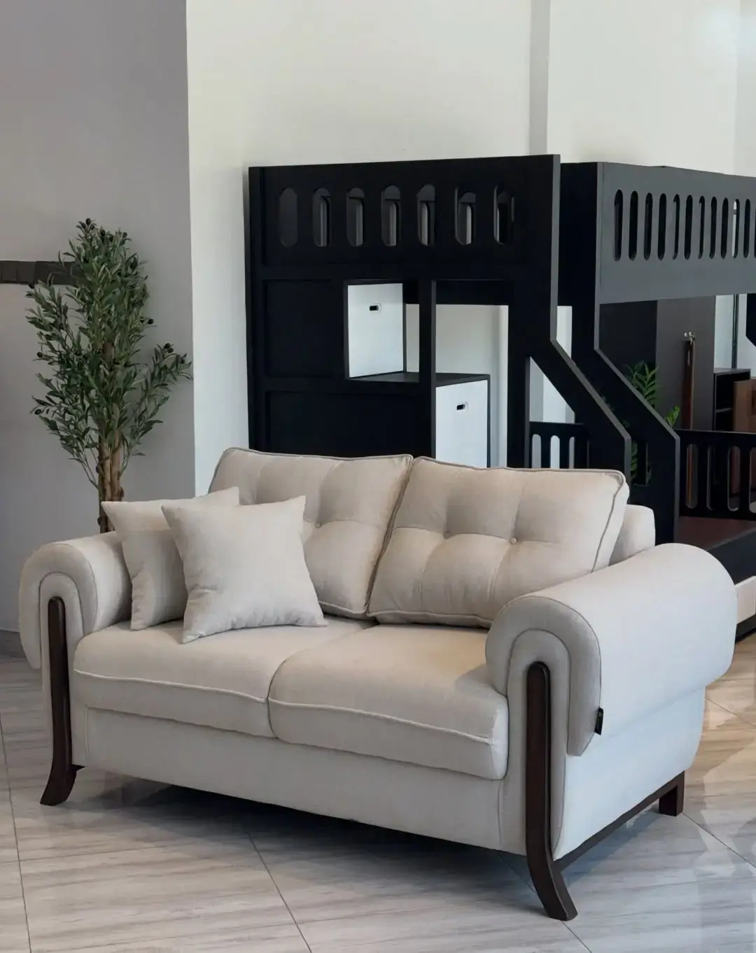 Cream sofa set Kenya with rolled arms, loose pillows, cushioned seat, and dark wood-tone accents