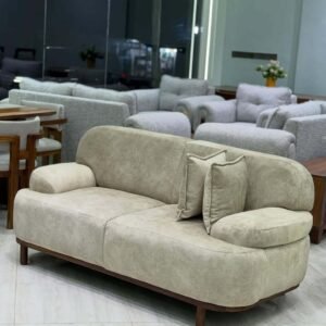 Beige 3 seater sofa with rounded arms, wood-tone legs and soft upholstery for Kenya living rooms