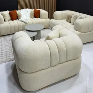 Cream sofa set Kenya with curved arms, channel-tufted cushions, and modern lounge layout