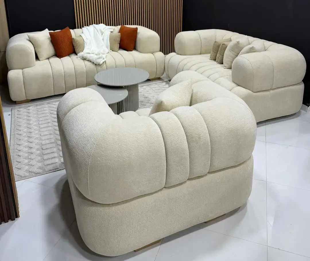Cream sofa set Kenya with curved arms, channel-tufted cushions, and modern lounge layout