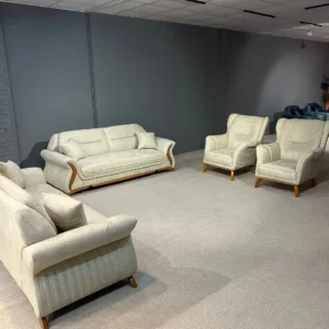 Cream sofa set Kenya with curved arms, wood-tone accents, matching chairs, and cushioned seating