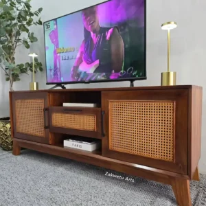 Rattan TV stand Kenya with wooden frame, cane-style doors, open shelves and raised legs