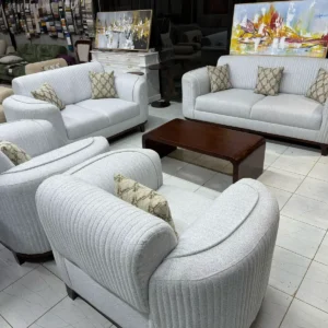 Light grey sofa set Kenya with ribbed channel detail, curved arms, cushioned seats, and throw pillows