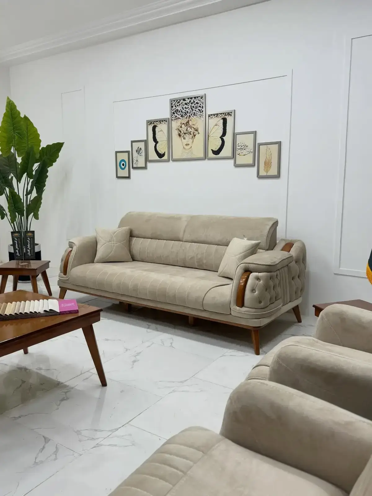 Beige sofa set Kenya with rolled arms, tufted side panels, wood-tone accents, and throw pillows